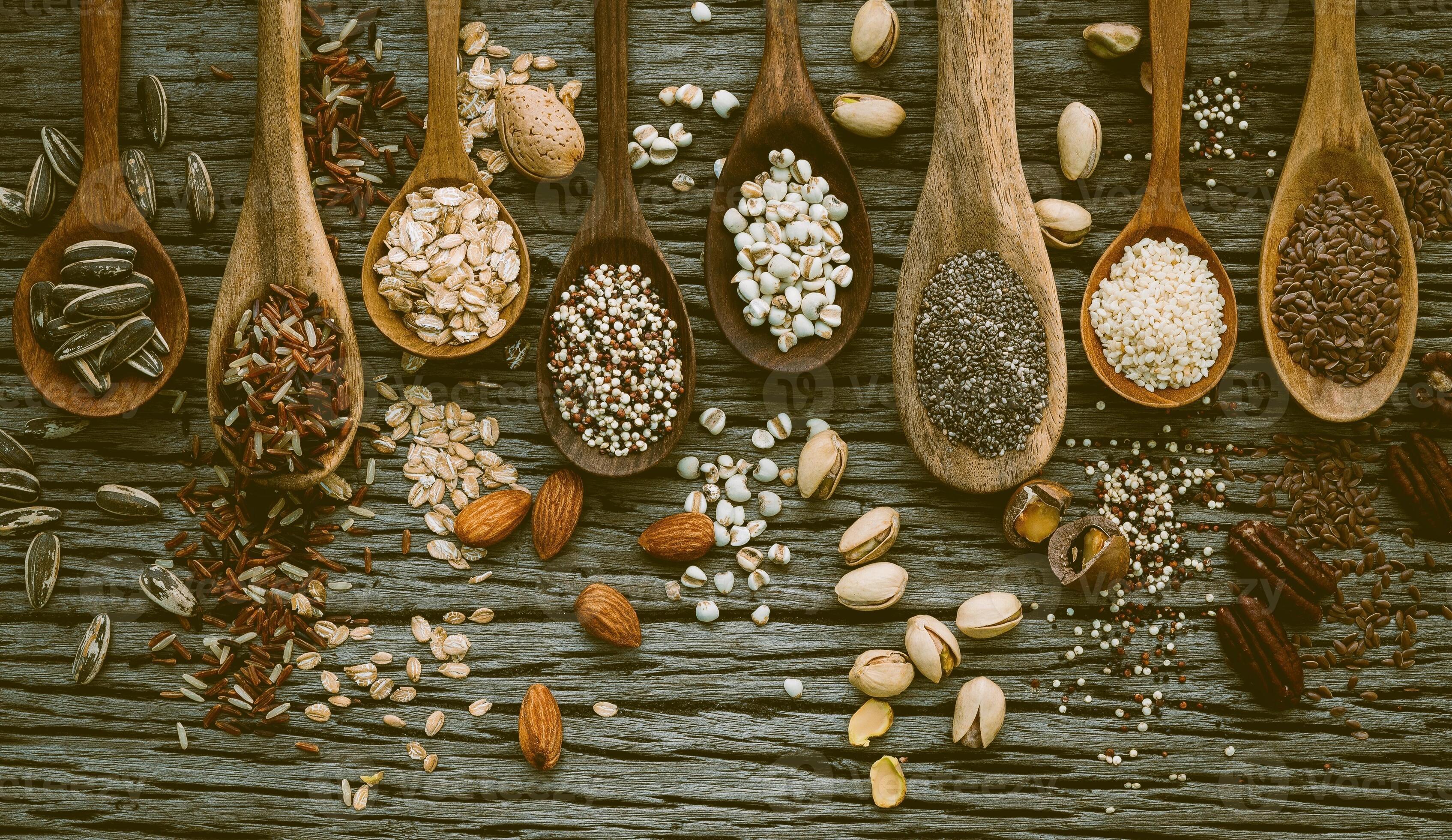 Different types of grains and cereals on shabby wooden background