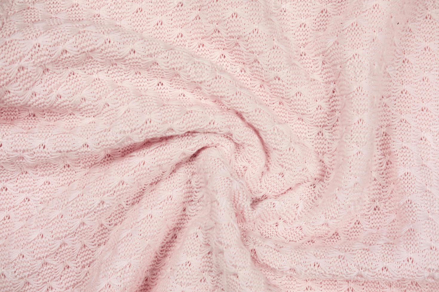 pink knitted fabric swirl. twisted soft sweater photo