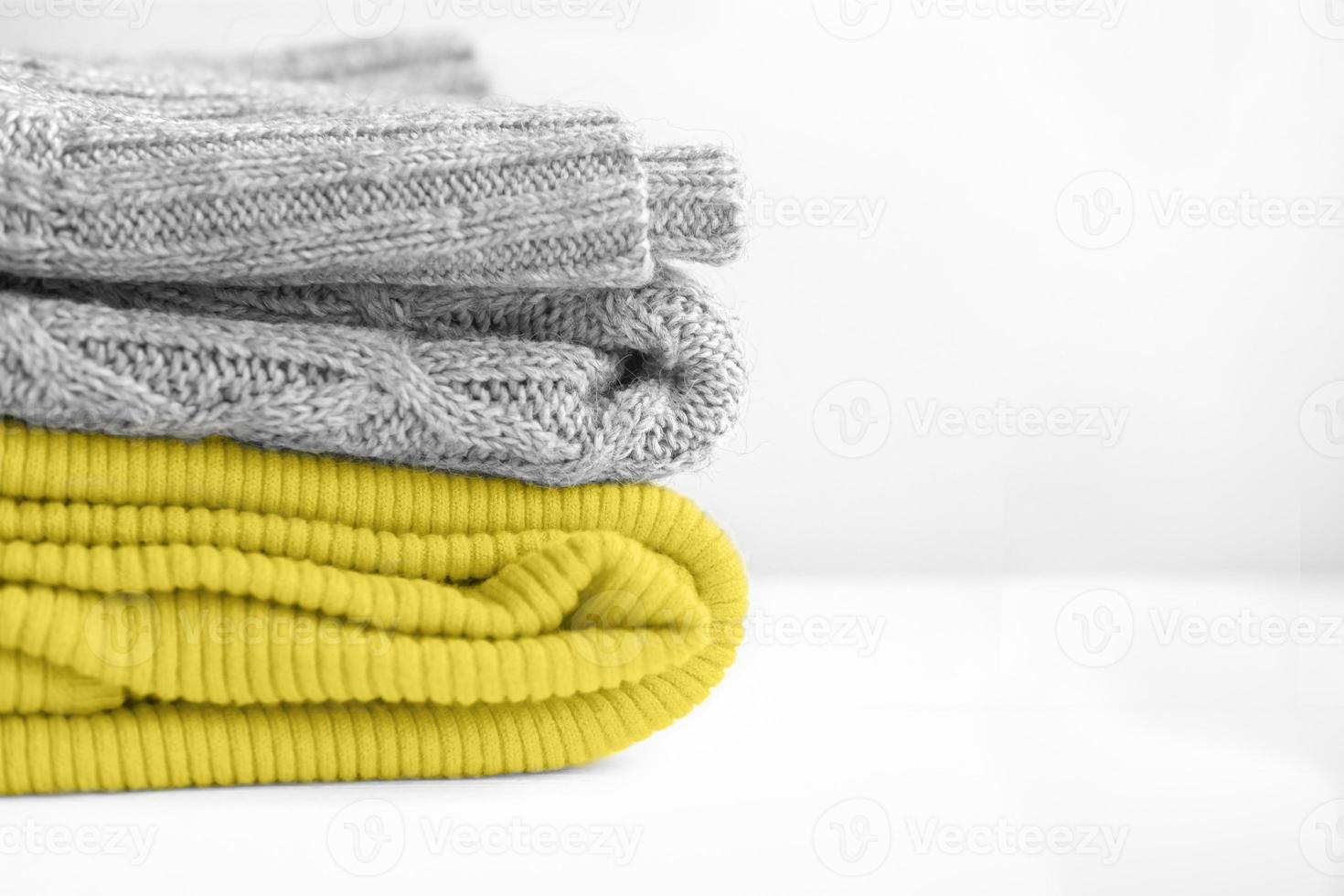 Stack of clothes colors 2021 illuminating yellow and ultimate gray. photo