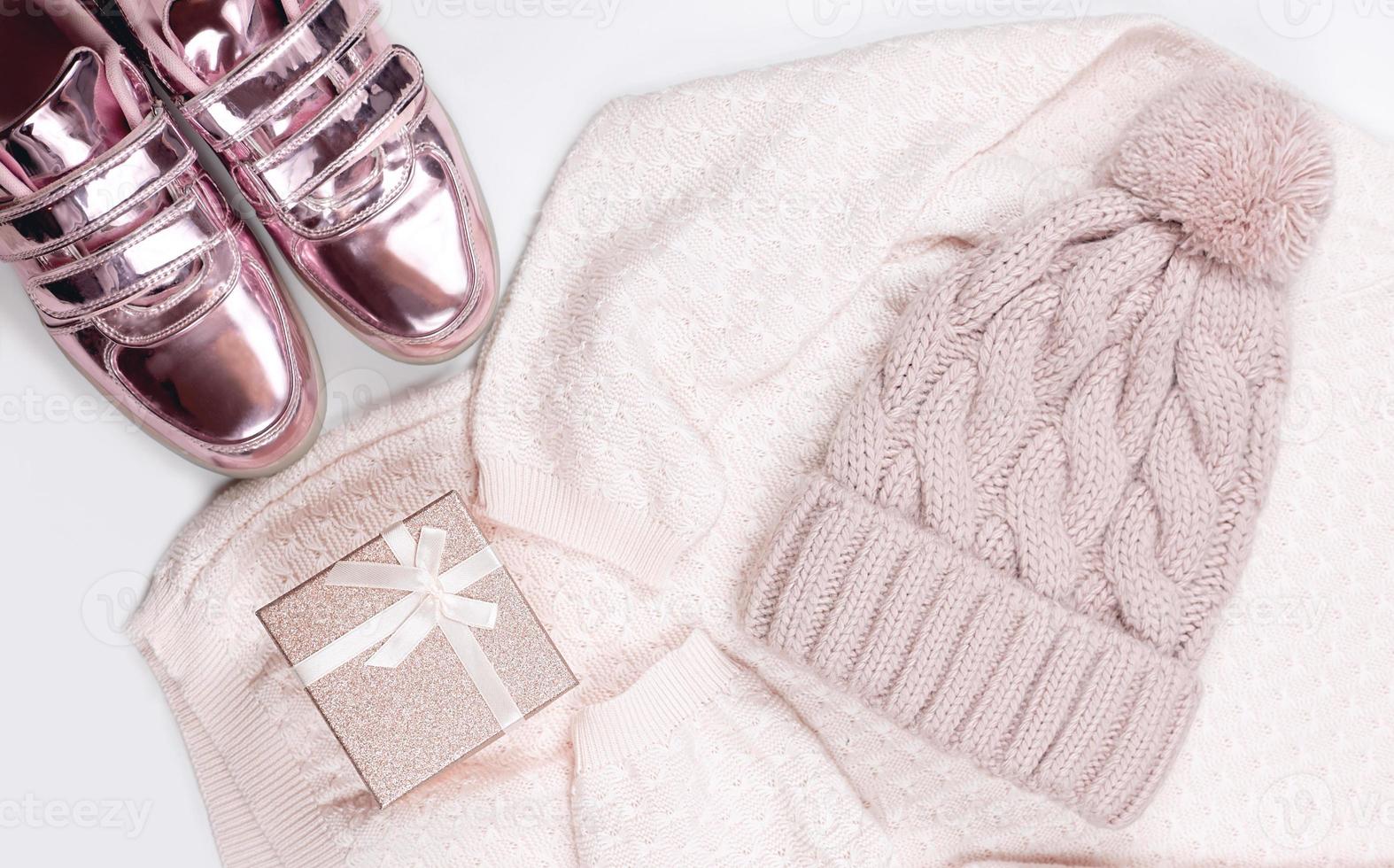 pastel pink women's pillover, shiny sneakers and hat flat lay. photo