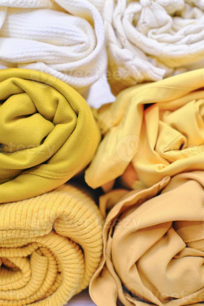 Clothes of yellow shades rolled up. photo