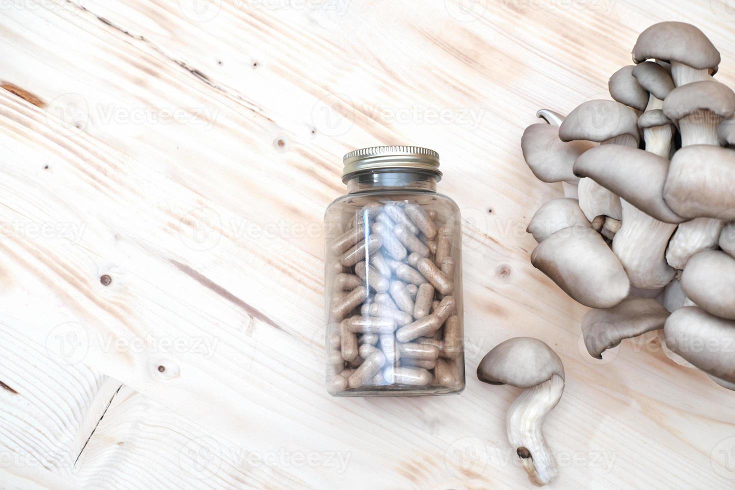 mushroom supplement capsules and fresh mushrooms photo