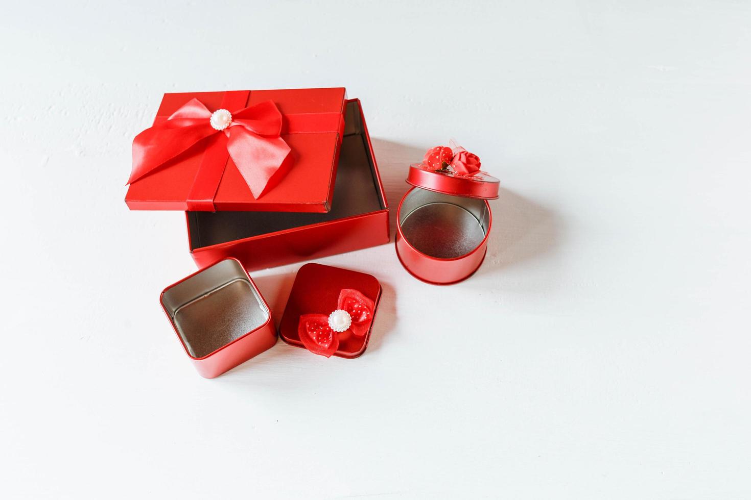 Red gift box  opened on white wooden table photo