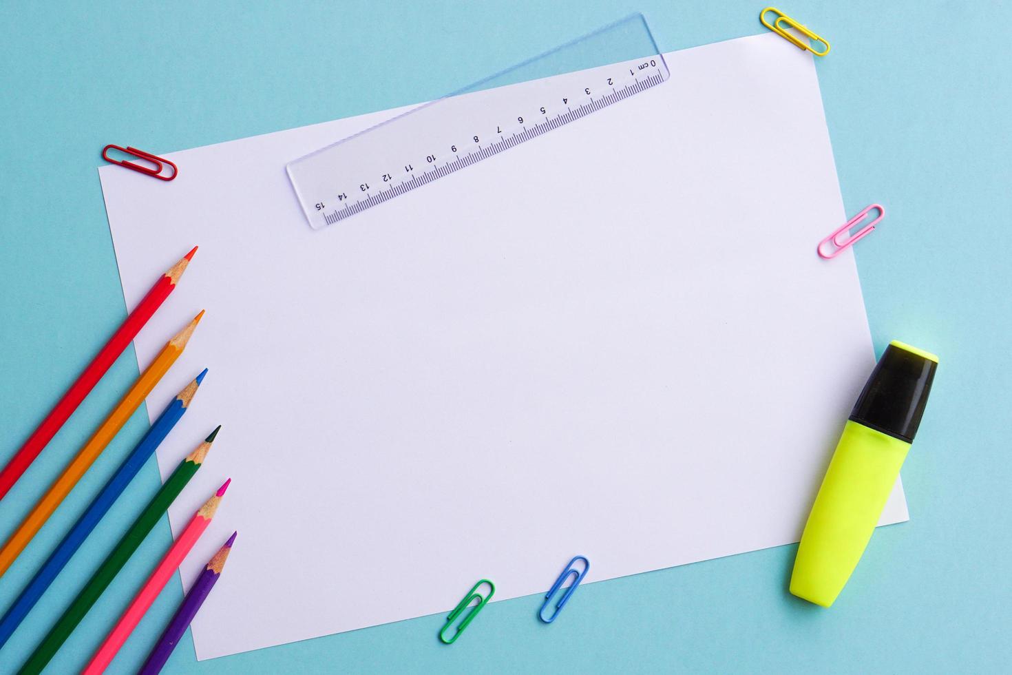 Top view of school supplies and office supplies on blue background. Learning, study, office equipment and presentation concept. photo