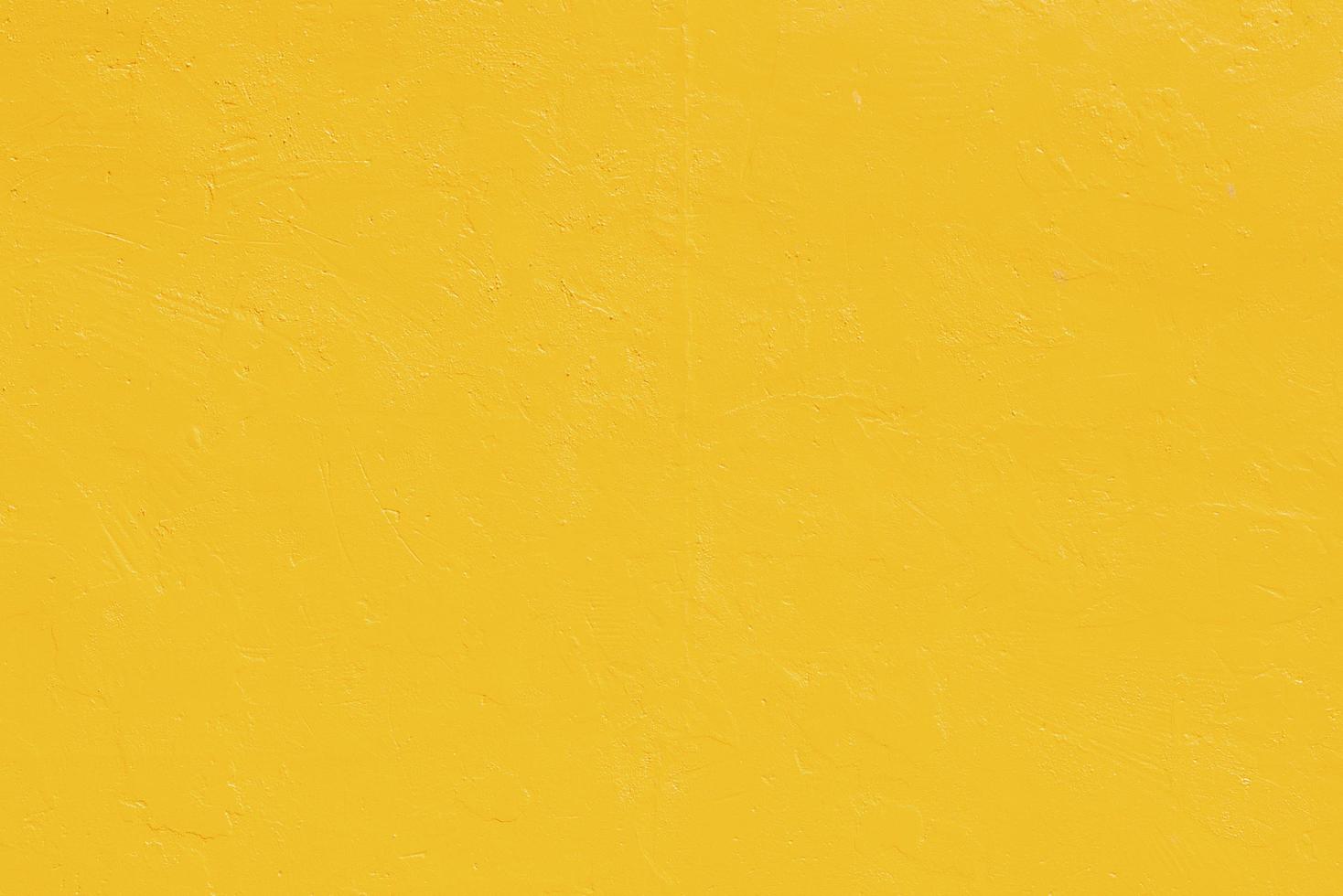 Vivid yellow stucco wall background. Yellow painted cement wall background texture. photo