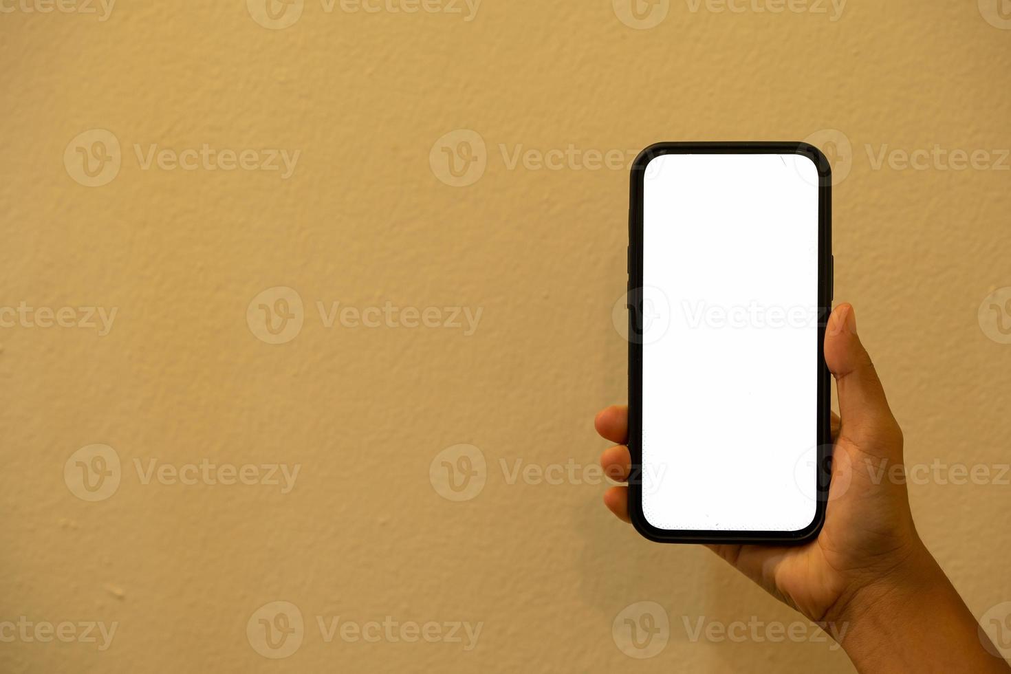 woman's hand holding a phone with a white photo