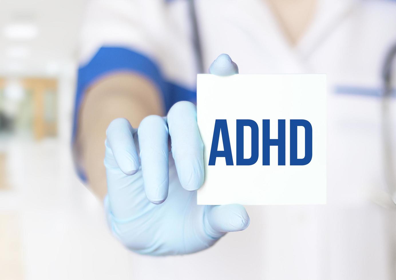 Attention Deficit Hyperactivity Disorder - ADHD - Doctor with card on white background photo