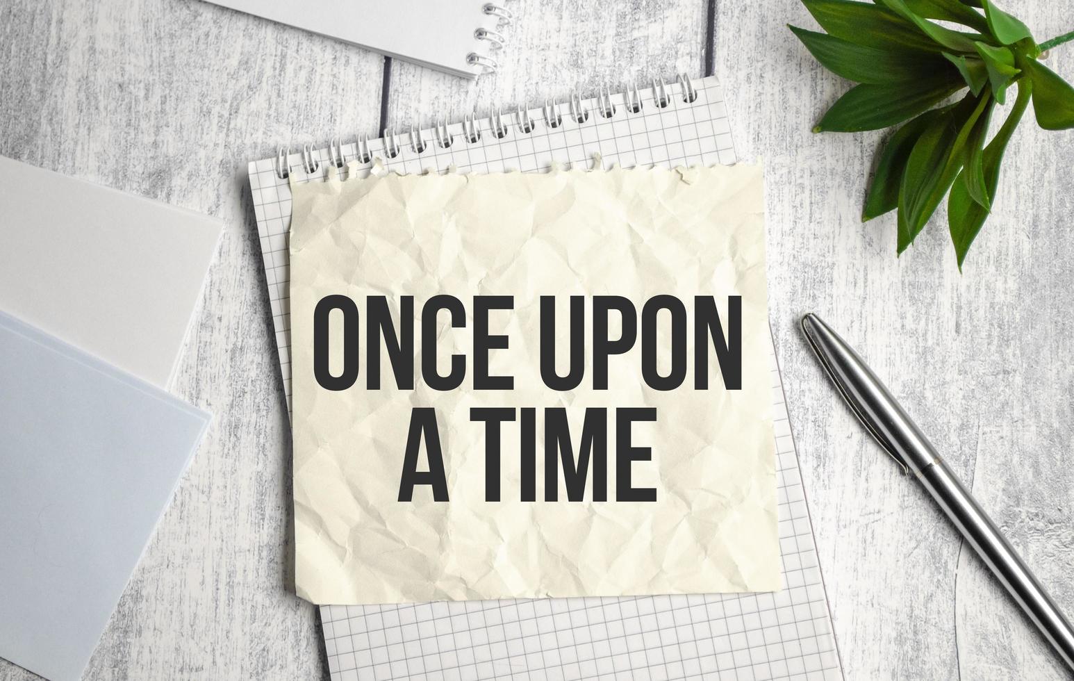 once upon a time text on documents on table photo