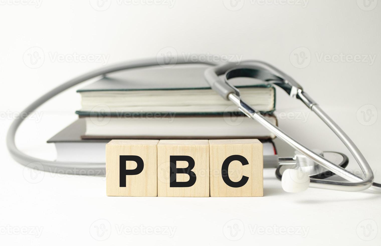 PBC Primary biliary cholangitis - word from wooden blocks with letters on wooden background photo