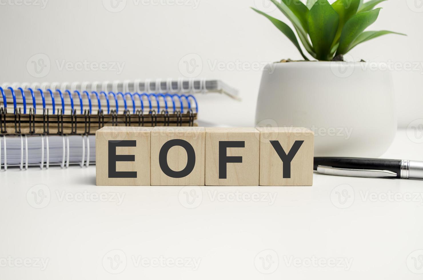 eofy word on wooden cubes on white background photo