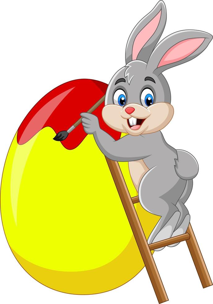 Easter bunny painting an egg vector