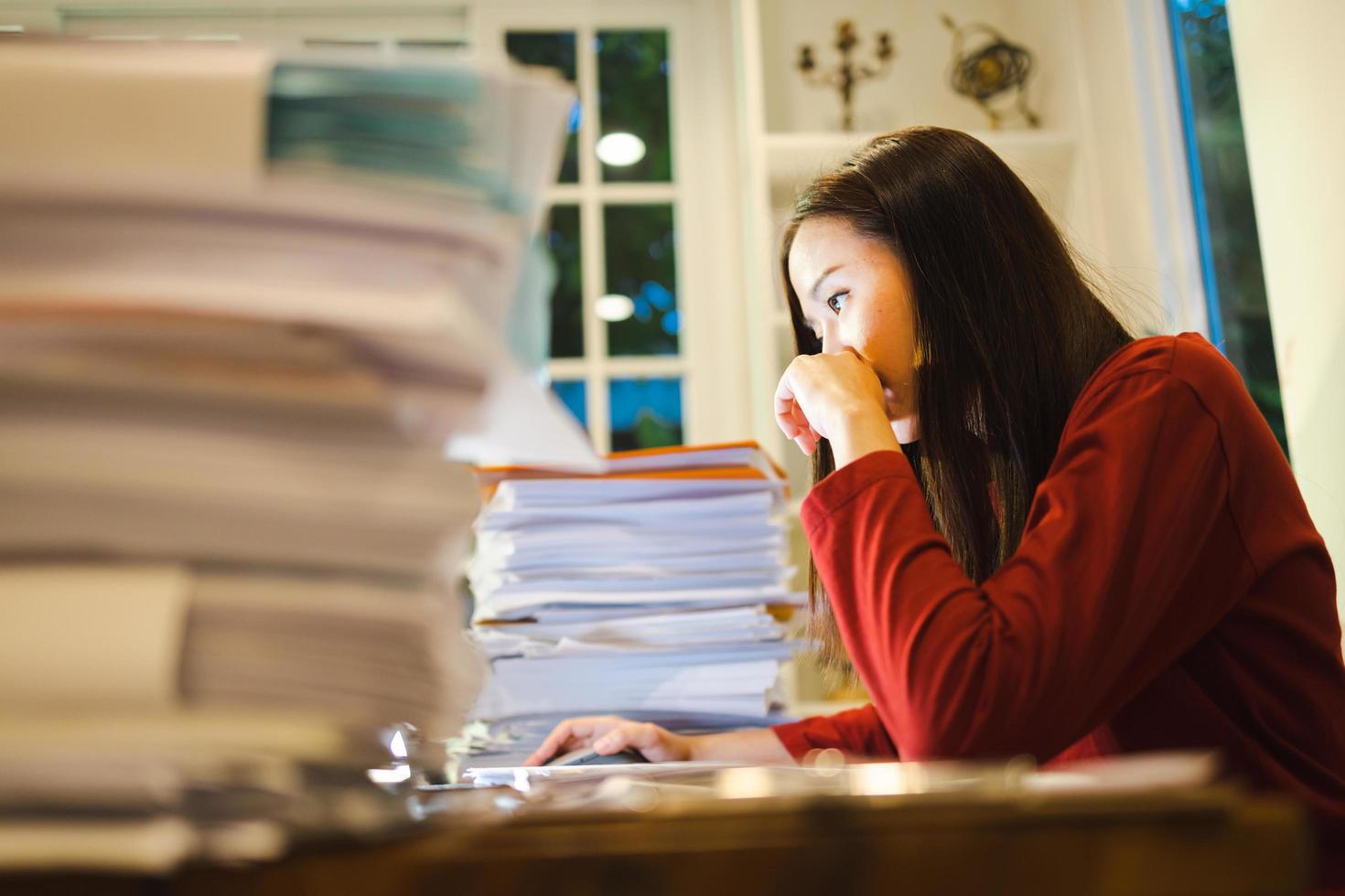 Asian businesswoman freelancer worried about the deadline of her report. Workaholic people concept photo