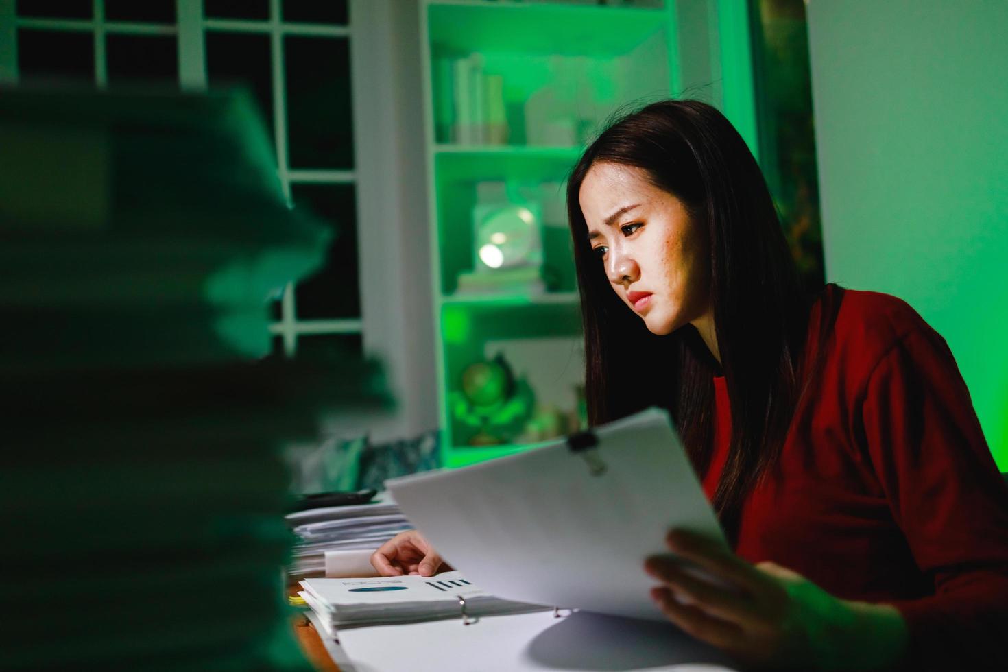 Fatigue female worker doing overtime project. Workaholic people concept photo