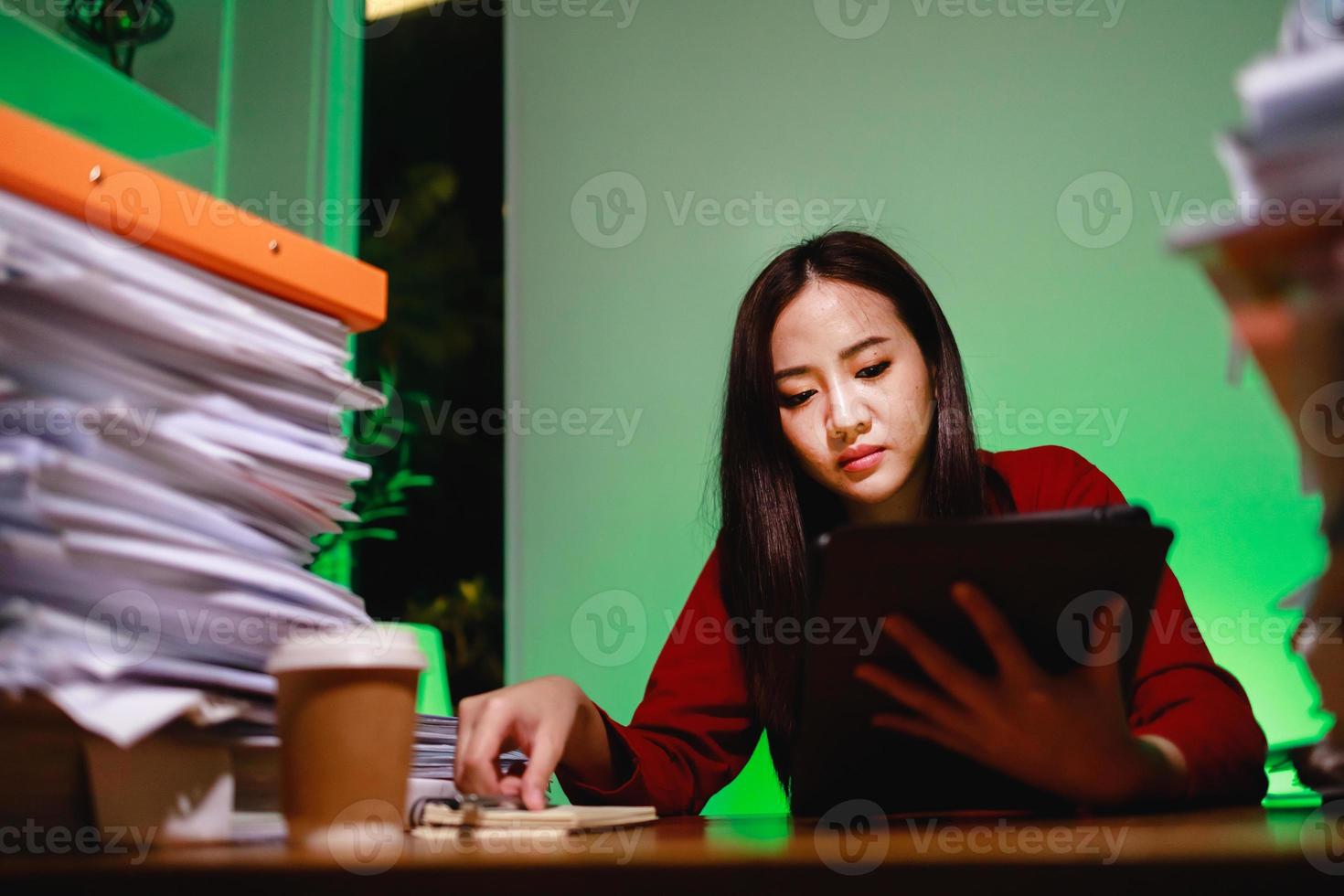 Overworked woman busy exhausted remote work using modern technology network wireless doing overtime photo