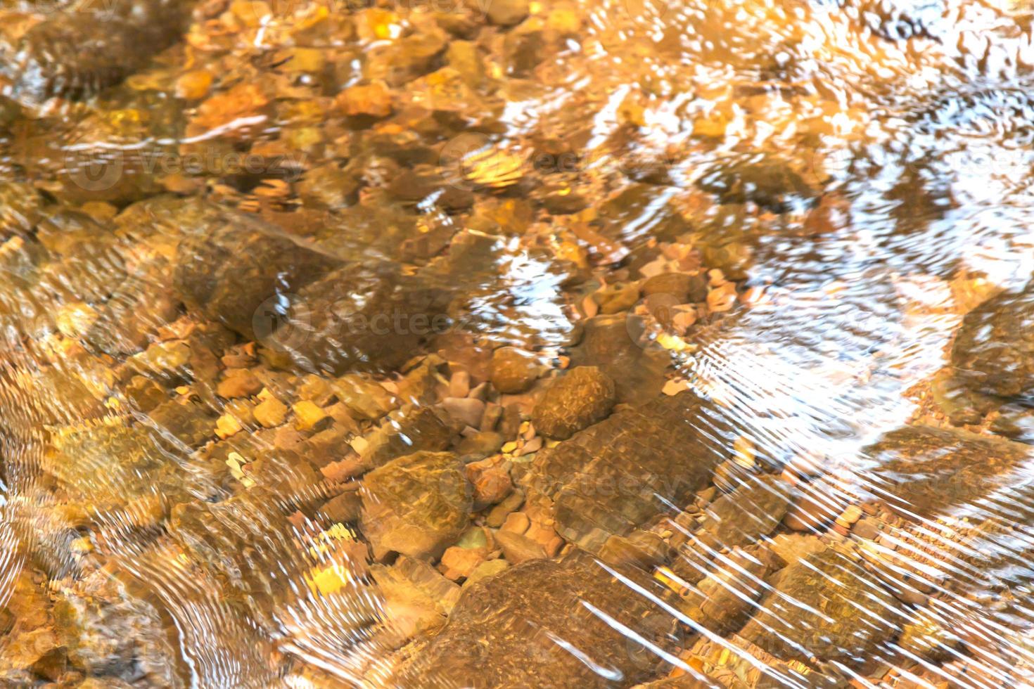 Rocks under the water clear with sunlight in the morning photo