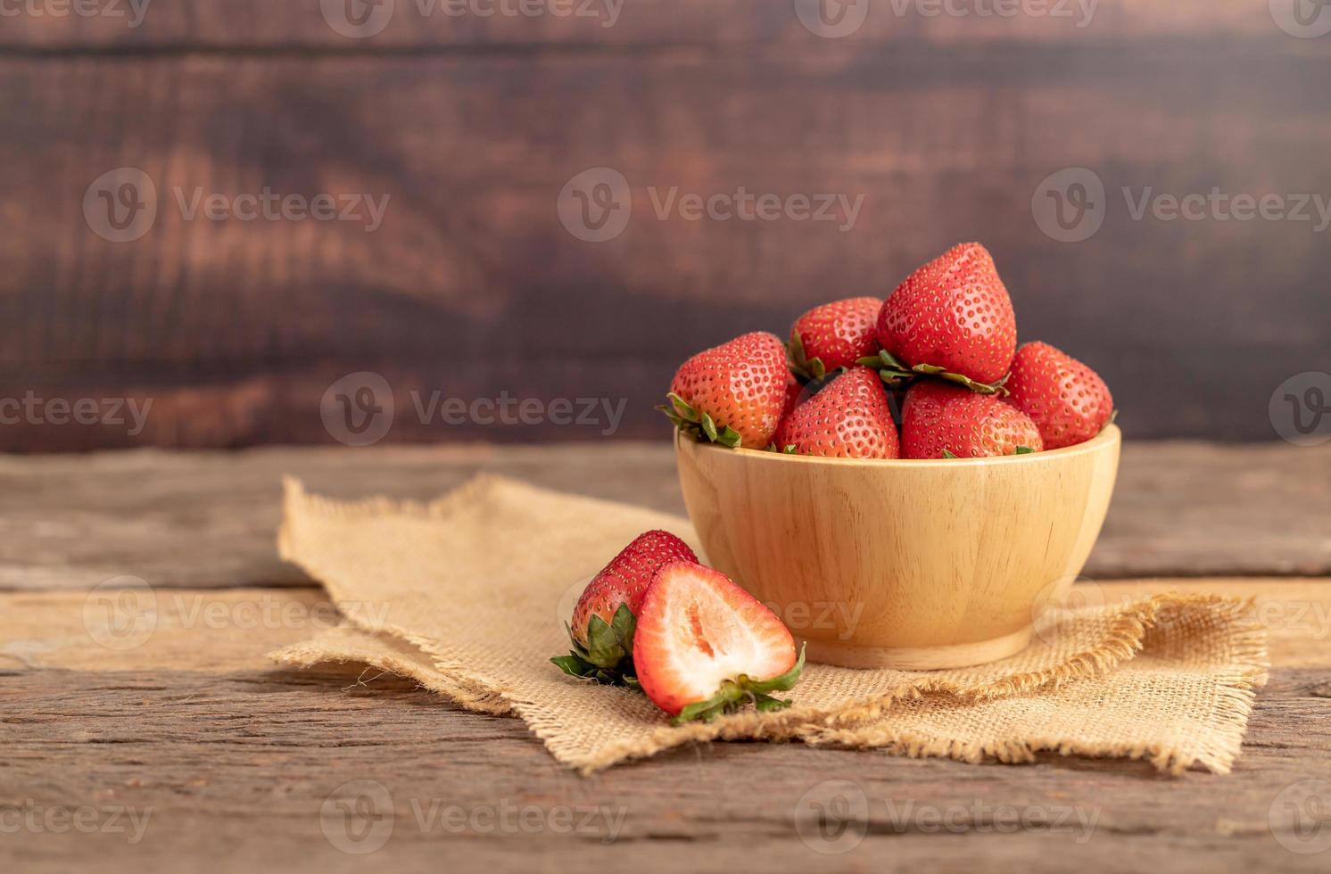 Strawberries are in a bowl on a brown sack photo