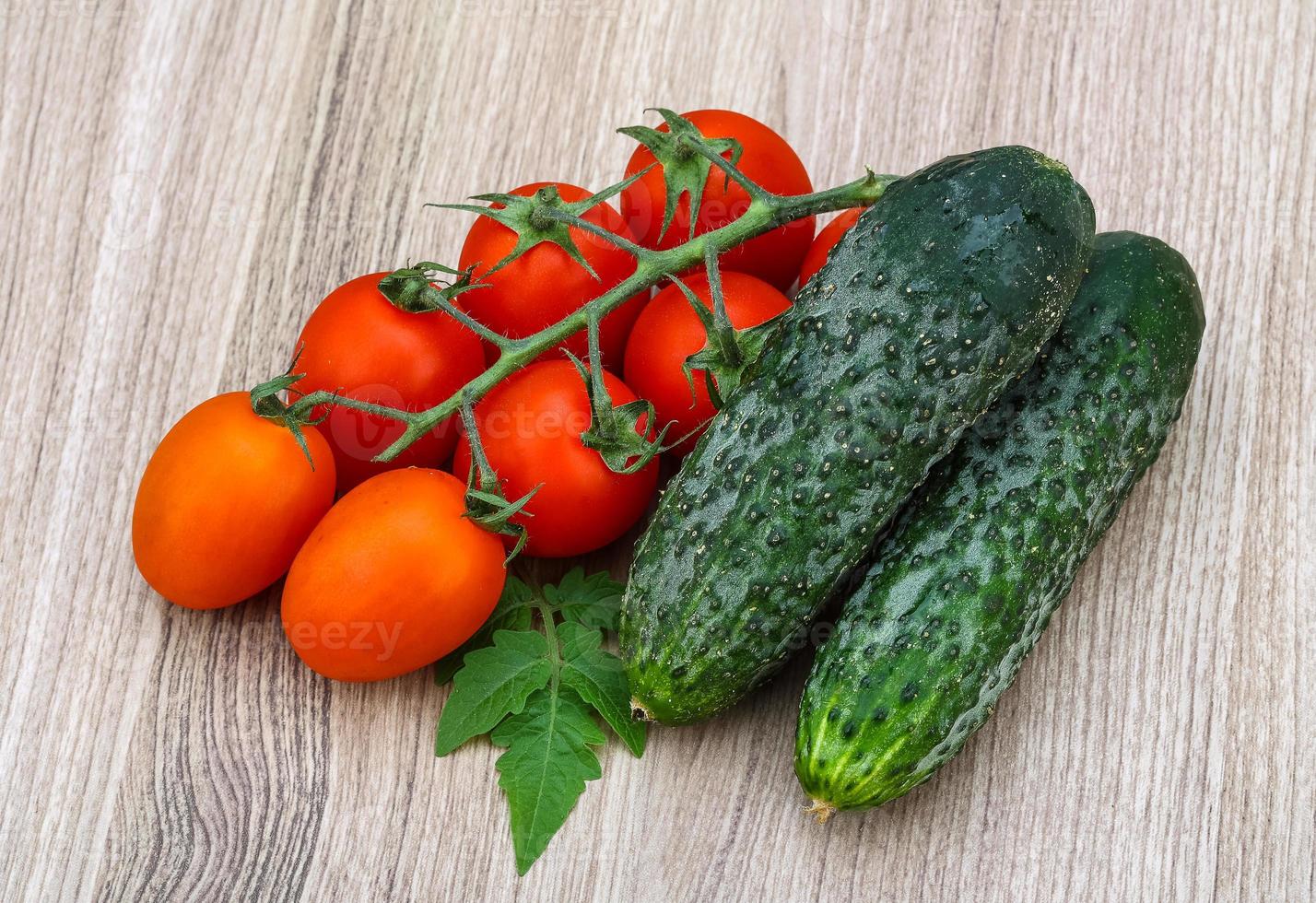 Cucumbers and tomatoes on the branch photo