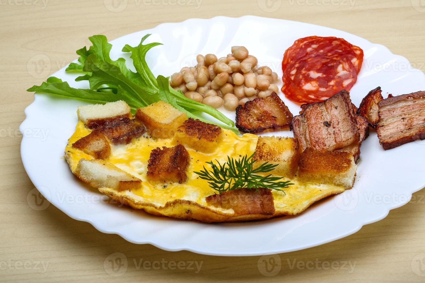 Breakfast with eggs, bacon and beans photo