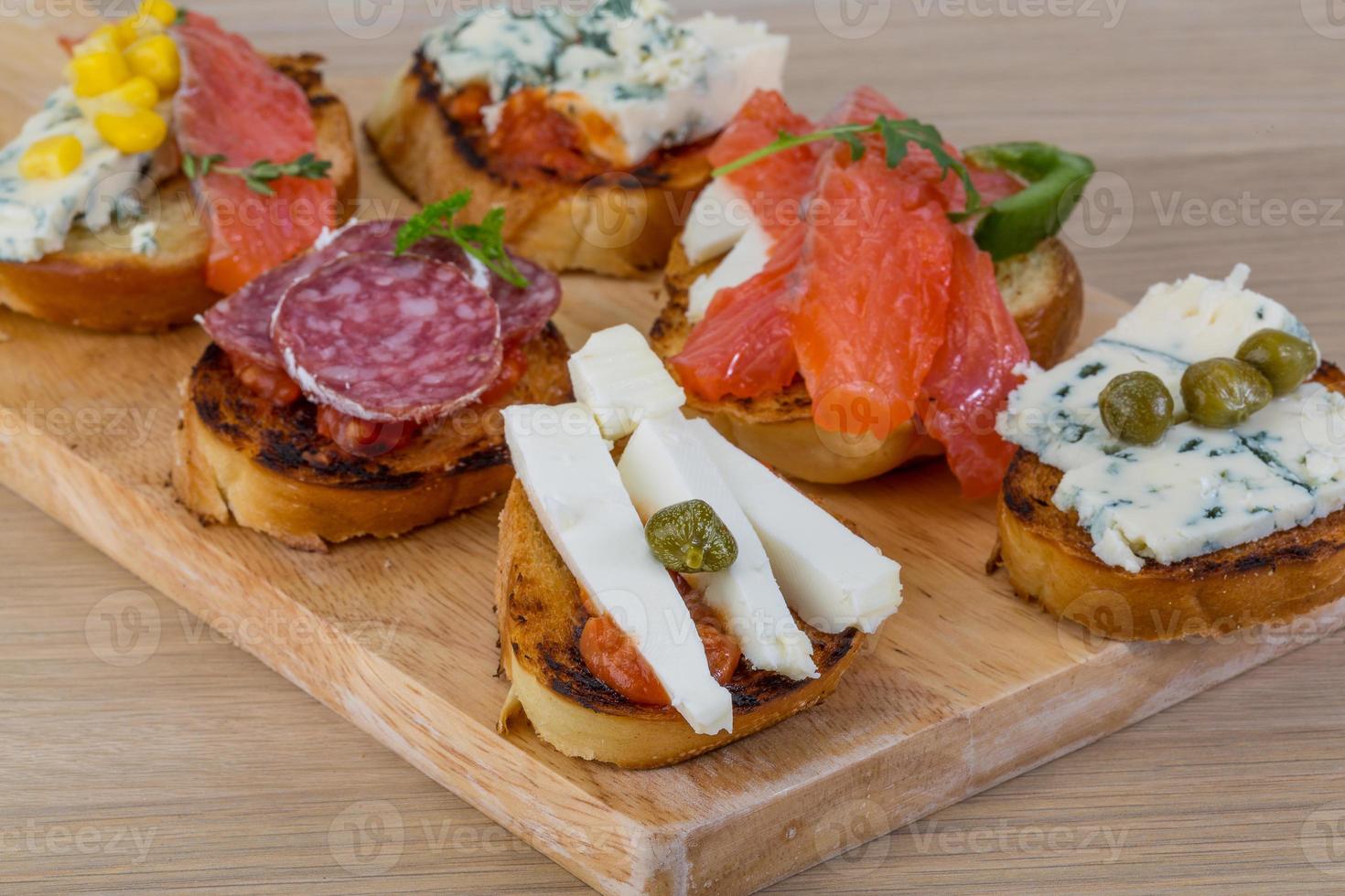 Tapas with cheese, salami and salmon photo