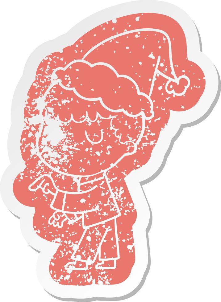 cartoon distressed sticker of a grumpy boy wearing santa hat vector
