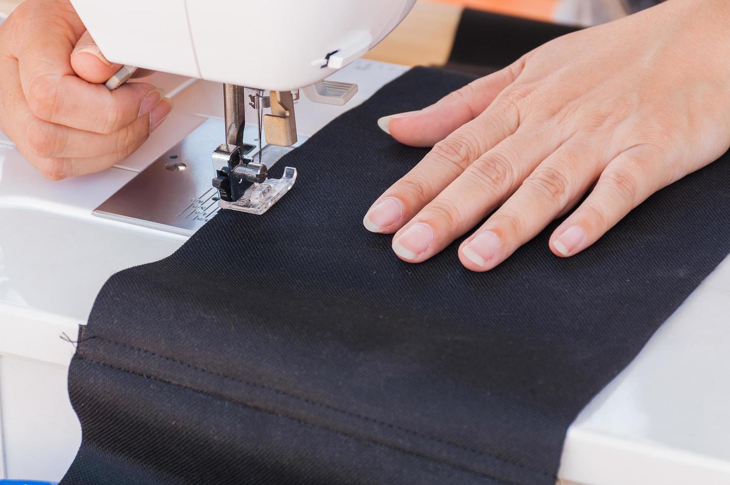 Woman's hands, doing her patchwork using sewing machine photo