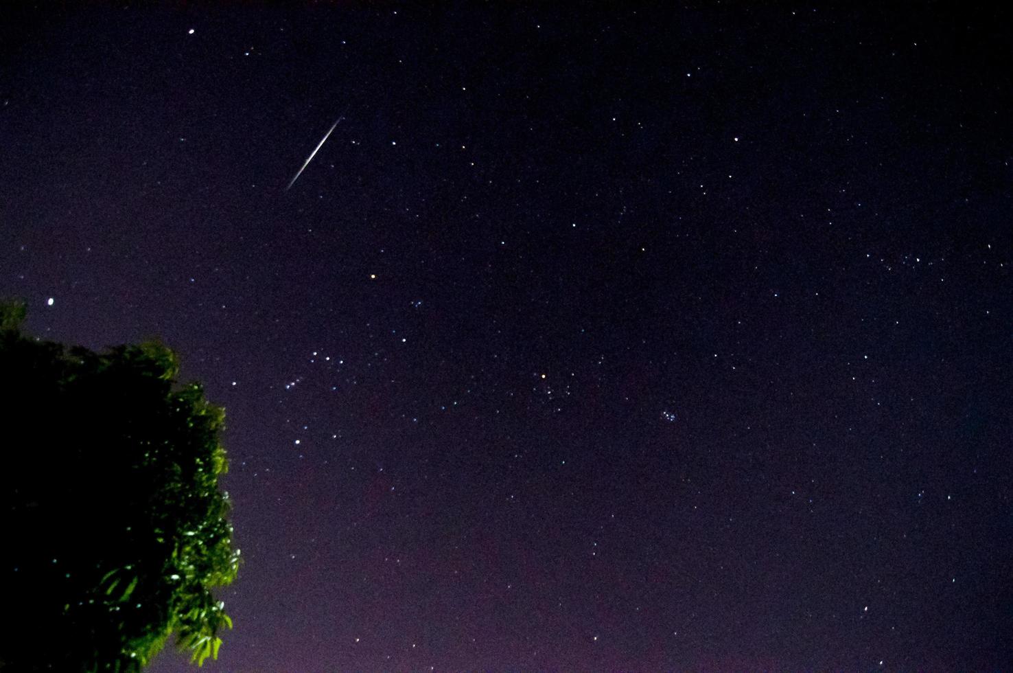 Man is using mobile phone take photo of Geminid meteor captured at 15DEC2015 from flat area in Chiang Mai city