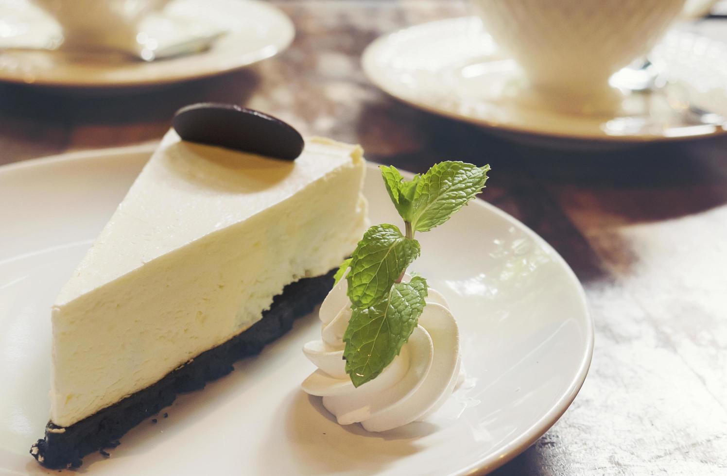 Cheese cake with cup of hot coffee in coffee shop photo