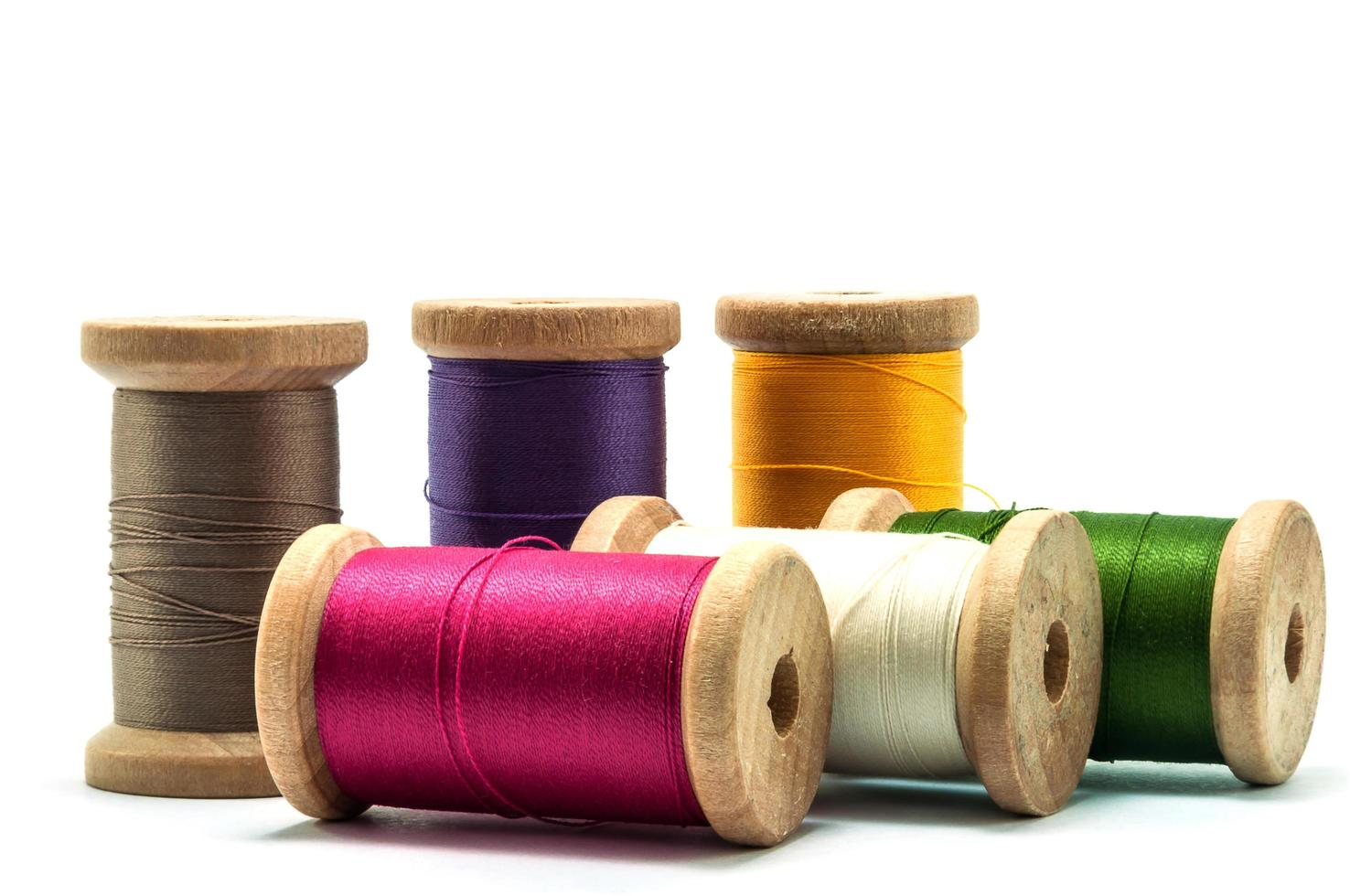 Isolated wooden spools of thread with a needle 8414307 Stock Photo at