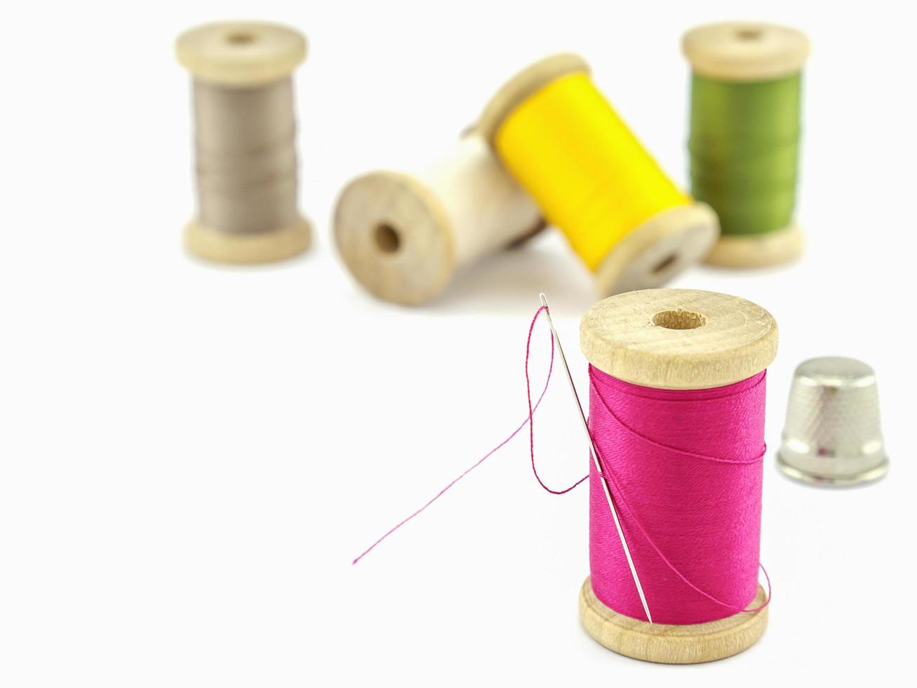 Selective focus of spool of thread embroidery set over white background. photo