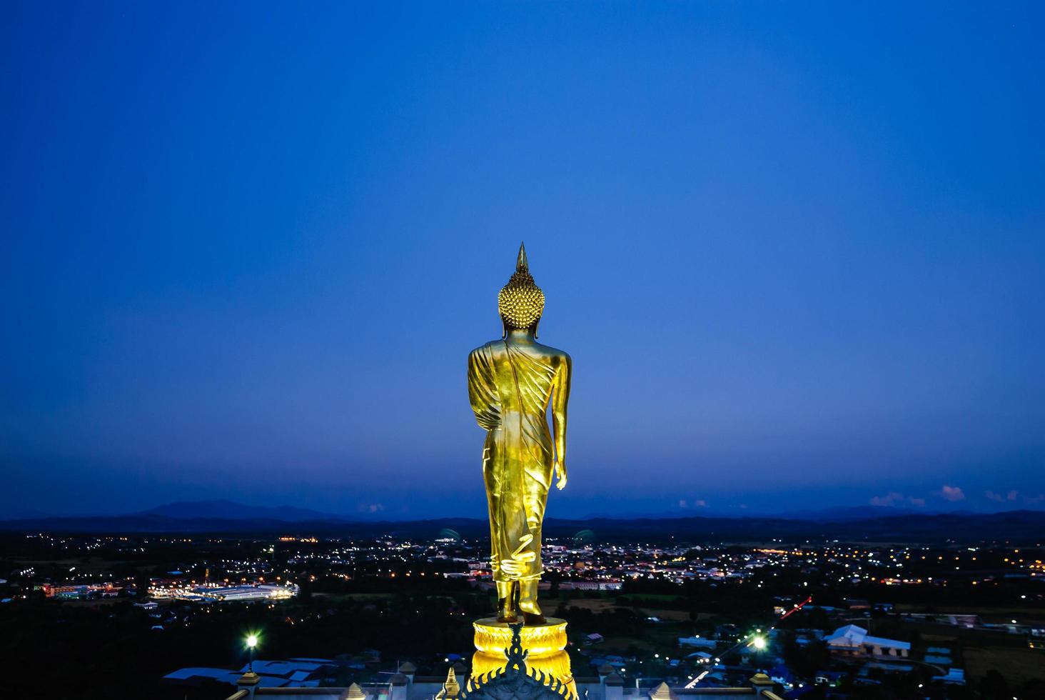 Buddha statue with blue sky twilight background at famous land mark Wat Phra That Khao Noi Nan province northern Thailand photo