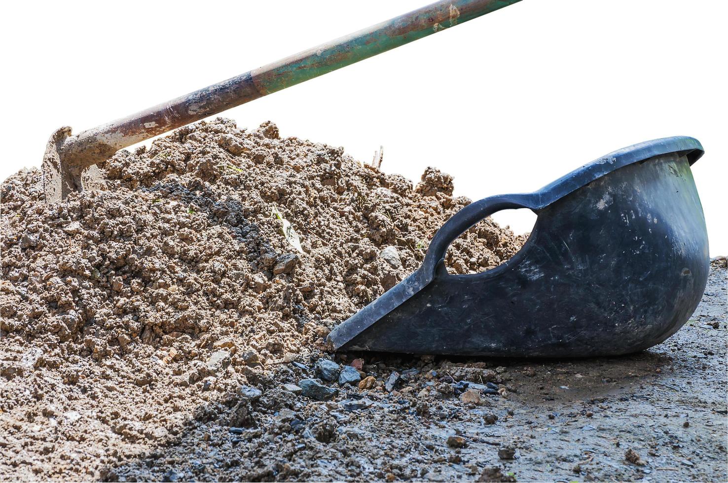 Hoe and clam-shell shaped bucket and soil mound isolated over white background. Photo includes clipping path.