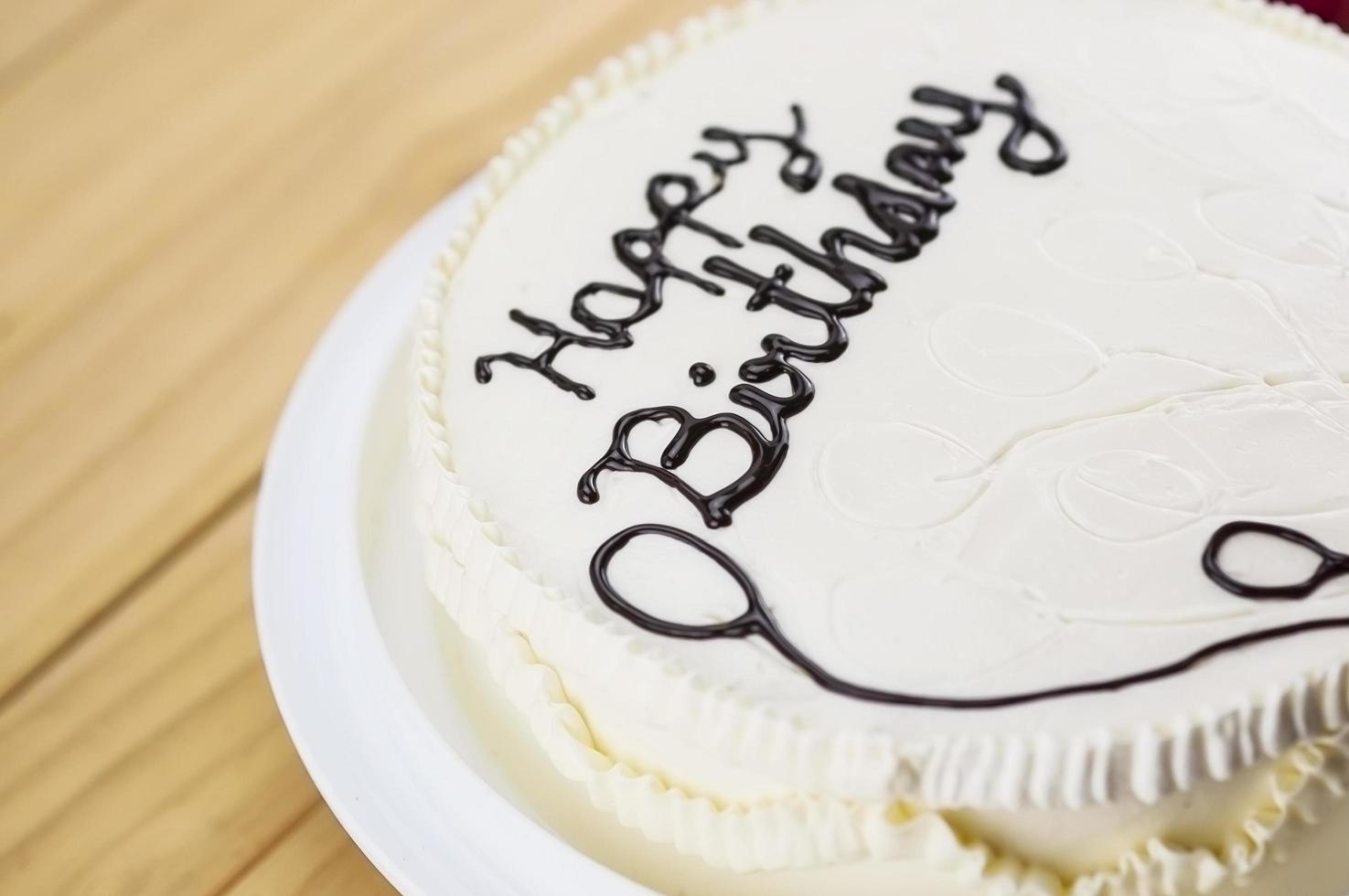 Birthday cake decoration using chocolate for making a word and drawing pictures photo