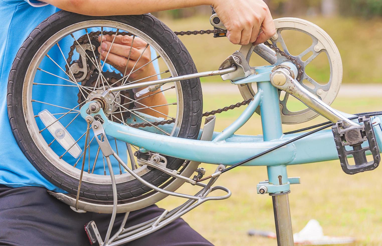 Man is fixing bicycle photo