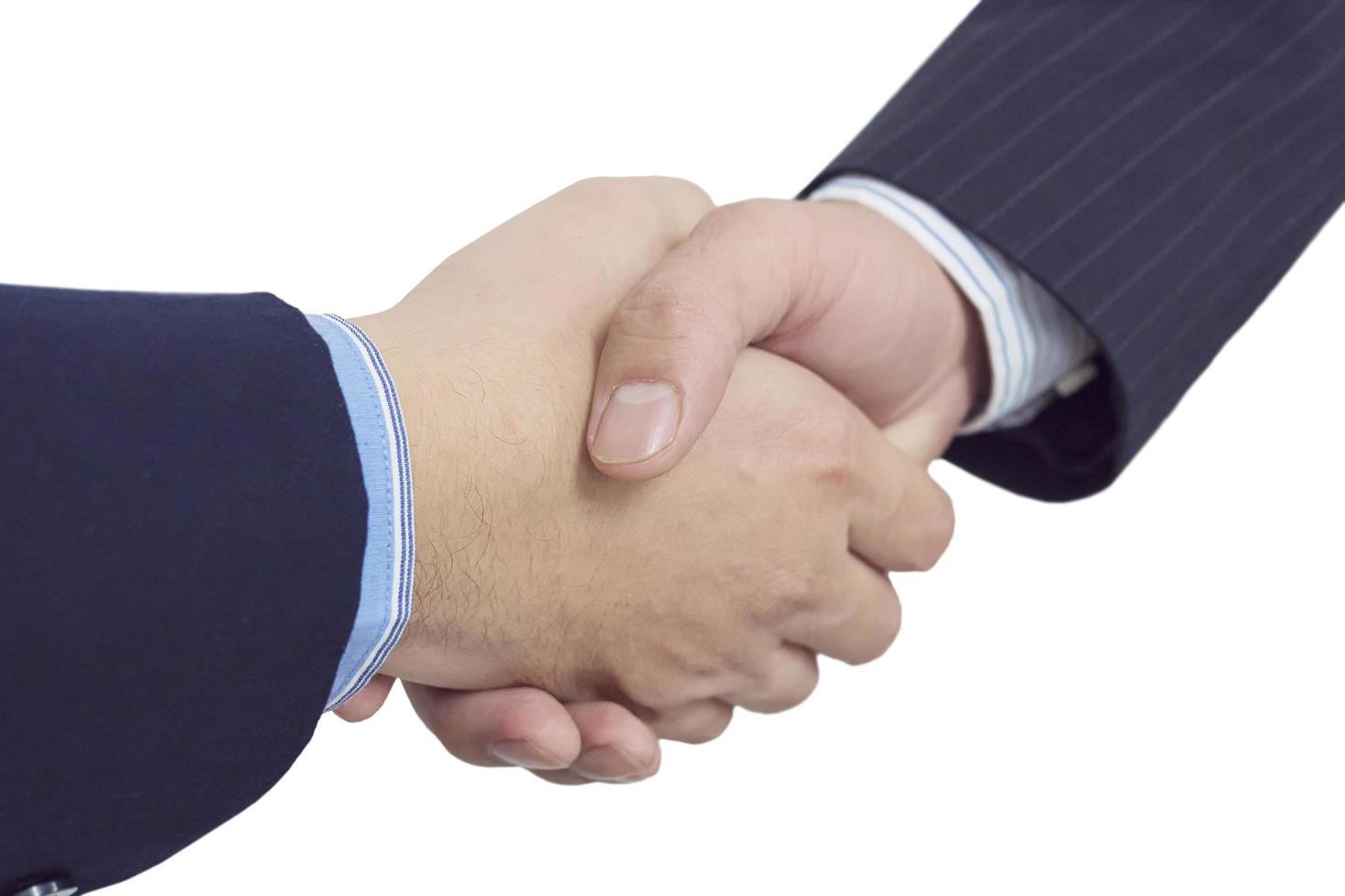 Close up of two business man shake hands firmly isolated over white. photo
