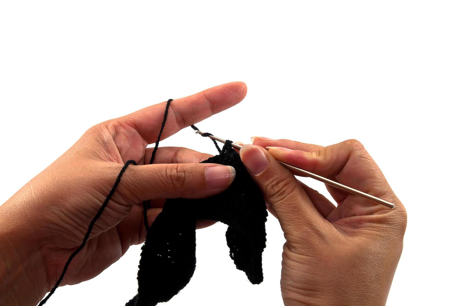 Women's hands doing crochet work photo