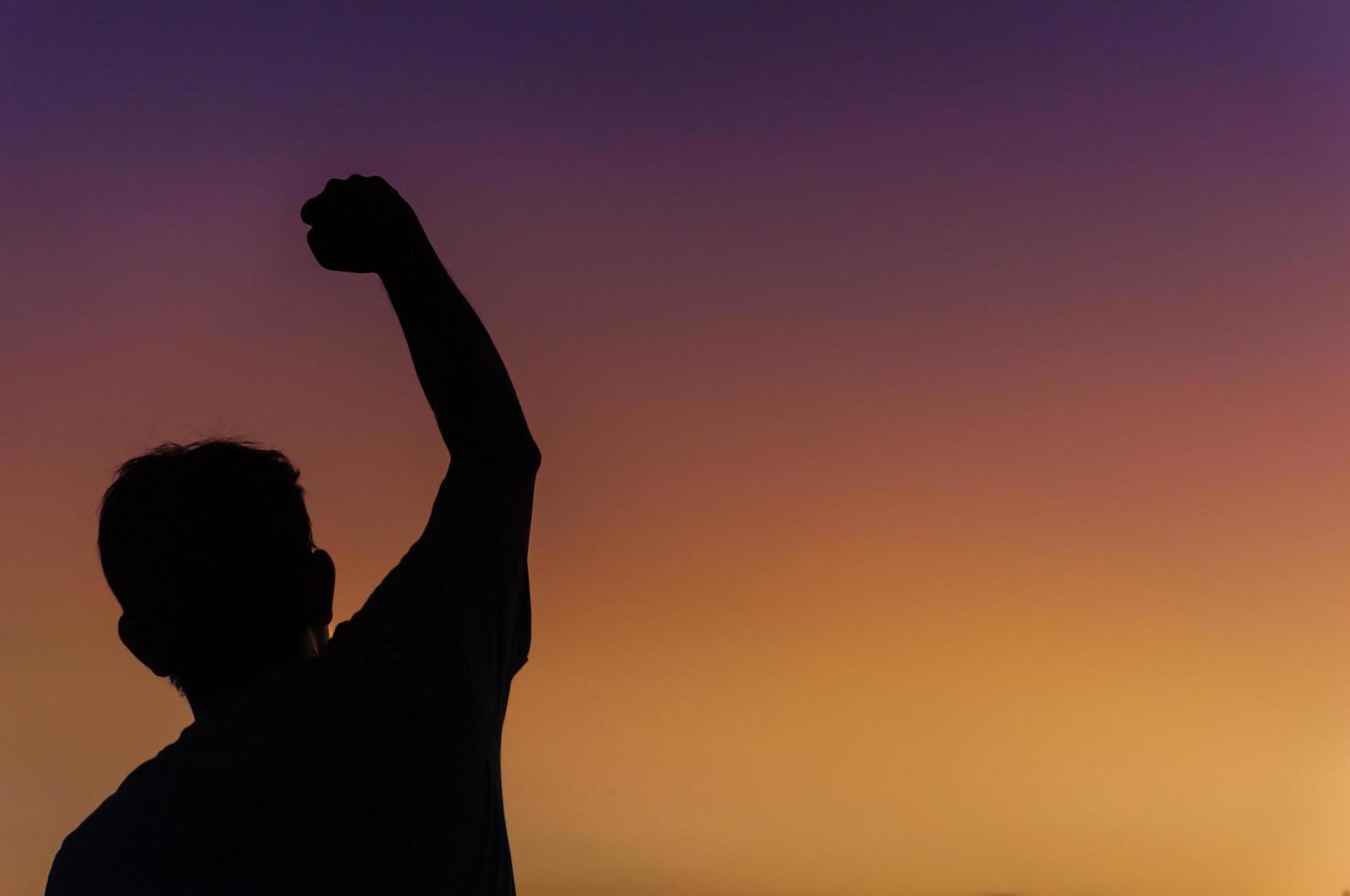 Silhouette of happy victory man photo