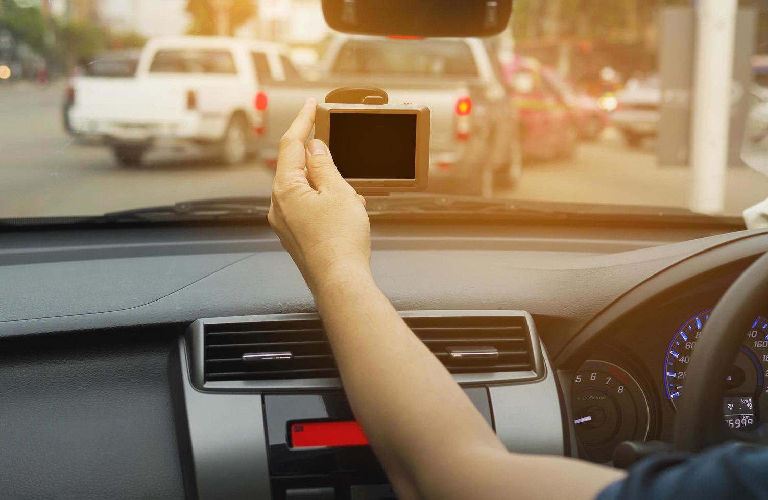 Man using navigator while driving a car in urban traffic road photo
