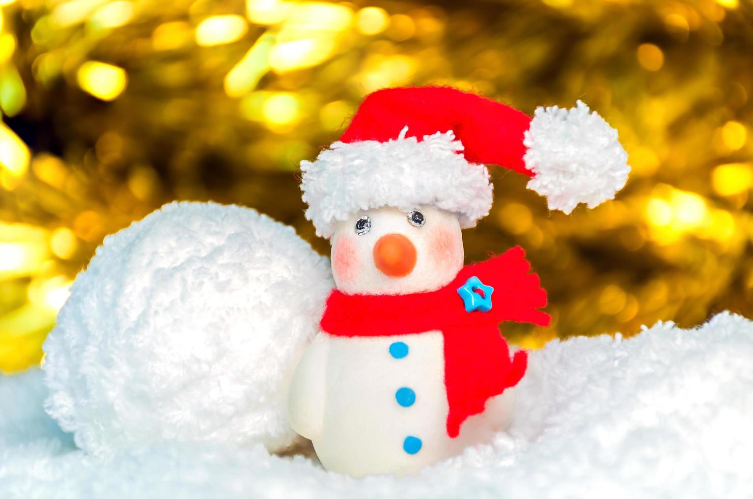 Snow man over blurred shiny yellow strip, and white background for Christmas new year decoration photo