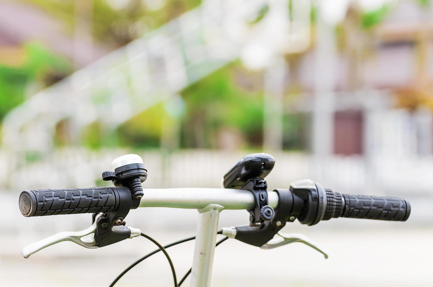 Closeup of bicycle hanCloseup of bicycle handlebar part with light and bell. Photo is focused at left handle. dlebar part with light and bell