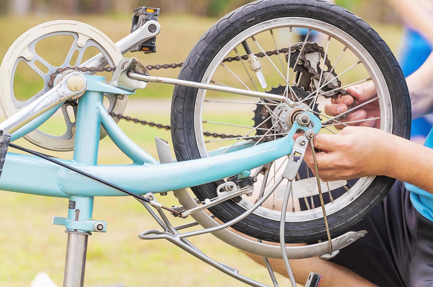 Man is fixing bicycle, selective focused. photo