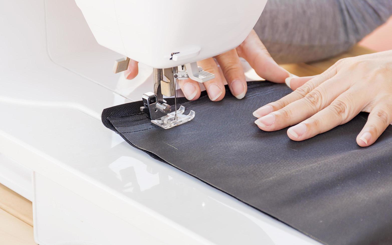 Woman's hands, doing her patchwork using sewing machine photo