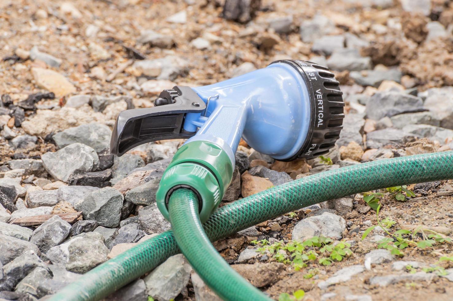 Garden hose nozzles and sprayer on ground photo