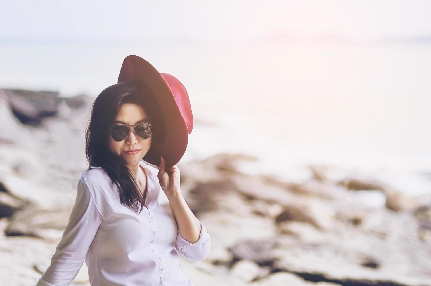 Beautiful lady on warm daylight sea beach in her vacation photo