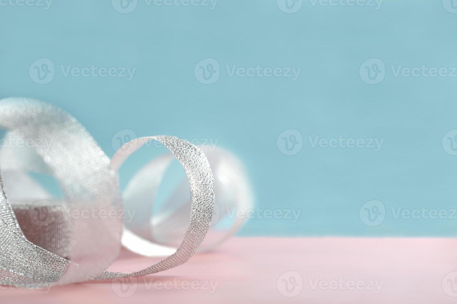 background of pastel pink and blue and silver glitter fabric ribbon. photo