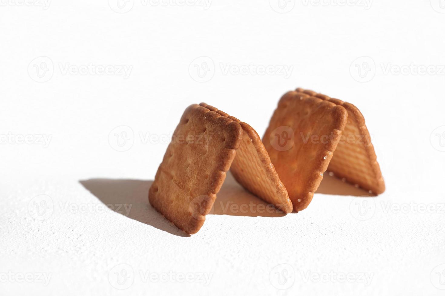 A close up shot of the delicious crispy crackers laid out in a shape of M letter on the white background photo