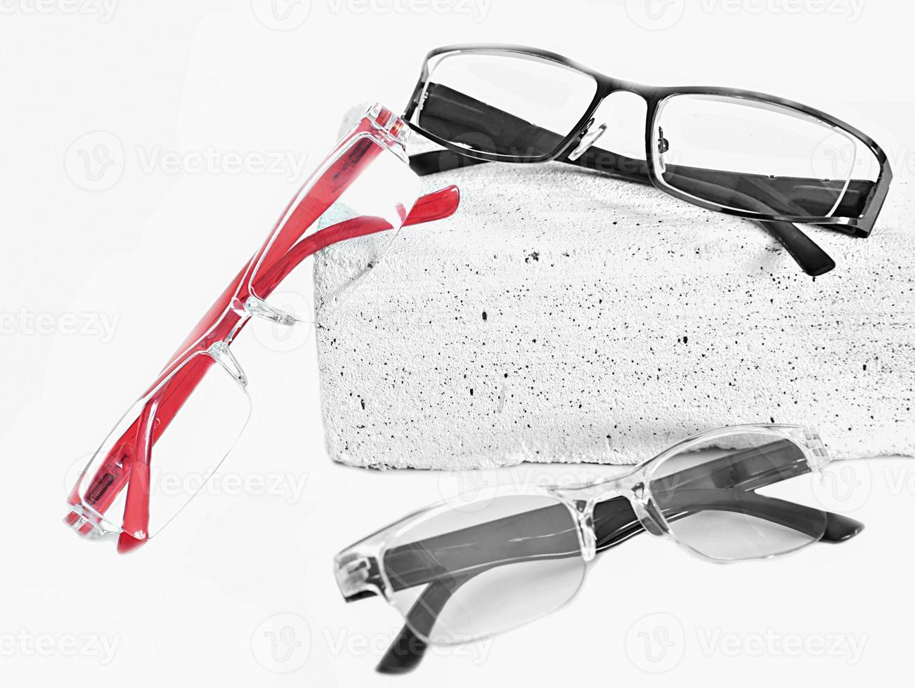 three various eyeglasses on trendy stone. Optical store, glasses selection, eye test, vision examination at optician, accessories concept. selective focus. photo