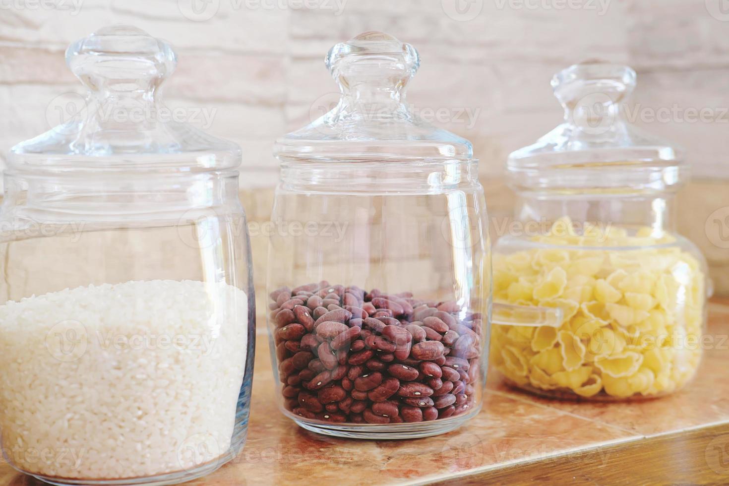 Food Ingredients In Glass Jars On A Kitchen Counter Top. Stock