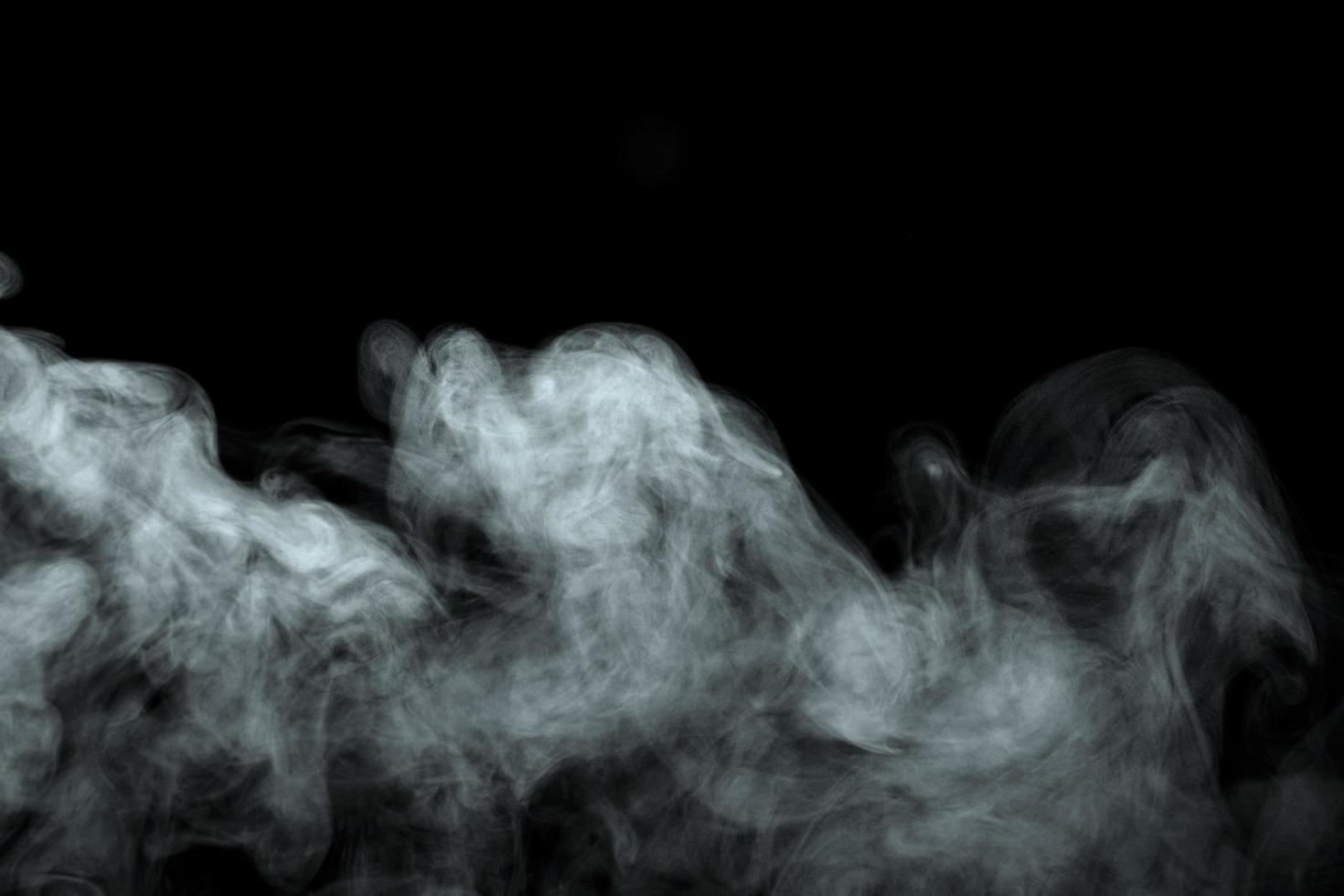 Abstract powder or smoke effect isolated on black background photo