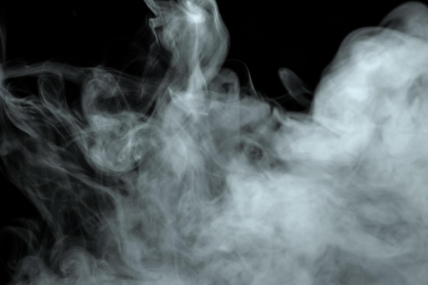 Abstract powder or smoke effect isolated on black background photo