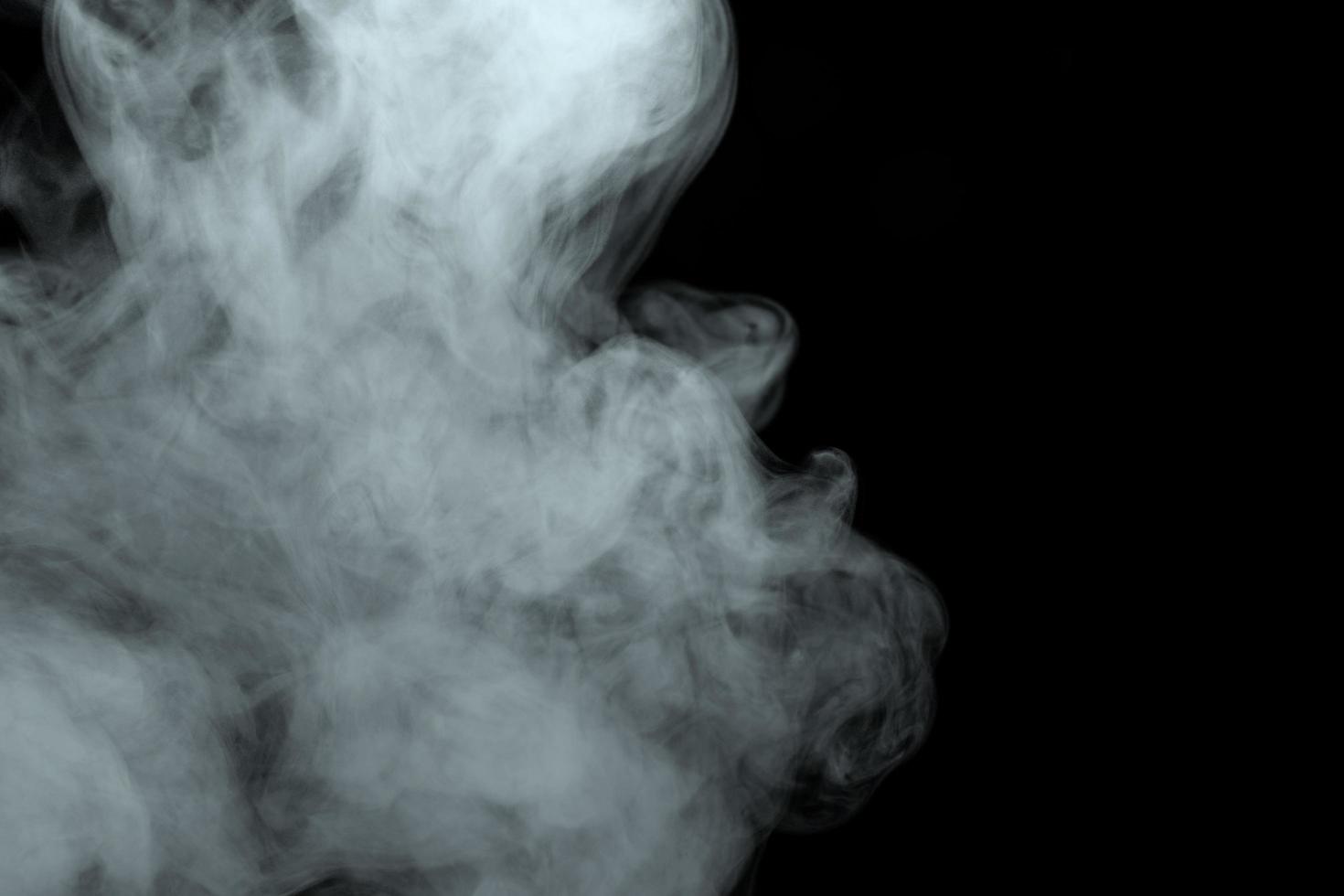 Abstract powder or smoke effect isolated on black background photo